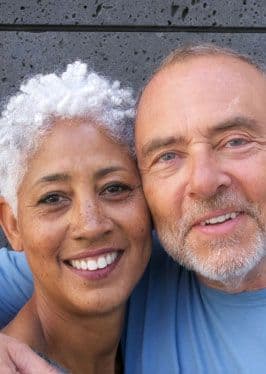 Charla and Alex in front of a wall, they met on Match dating app.