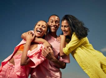 Two single women and a single man enjoying a Match dating event.